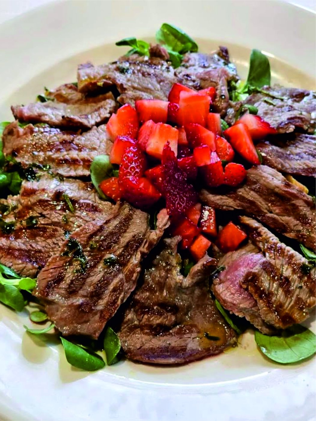 Tagliata di manzo con fragole servita in tavola